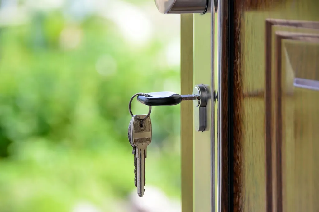 House keys hanging in a front door after a home purchase