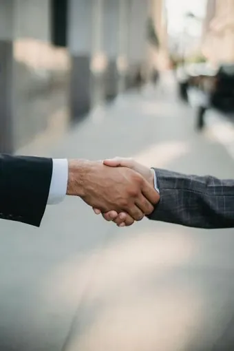 Real estate attorney shaking hands with a client after a home closing