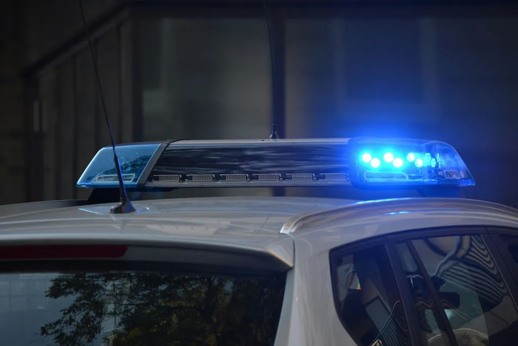 Police car with emergency lights on during a traffic stop