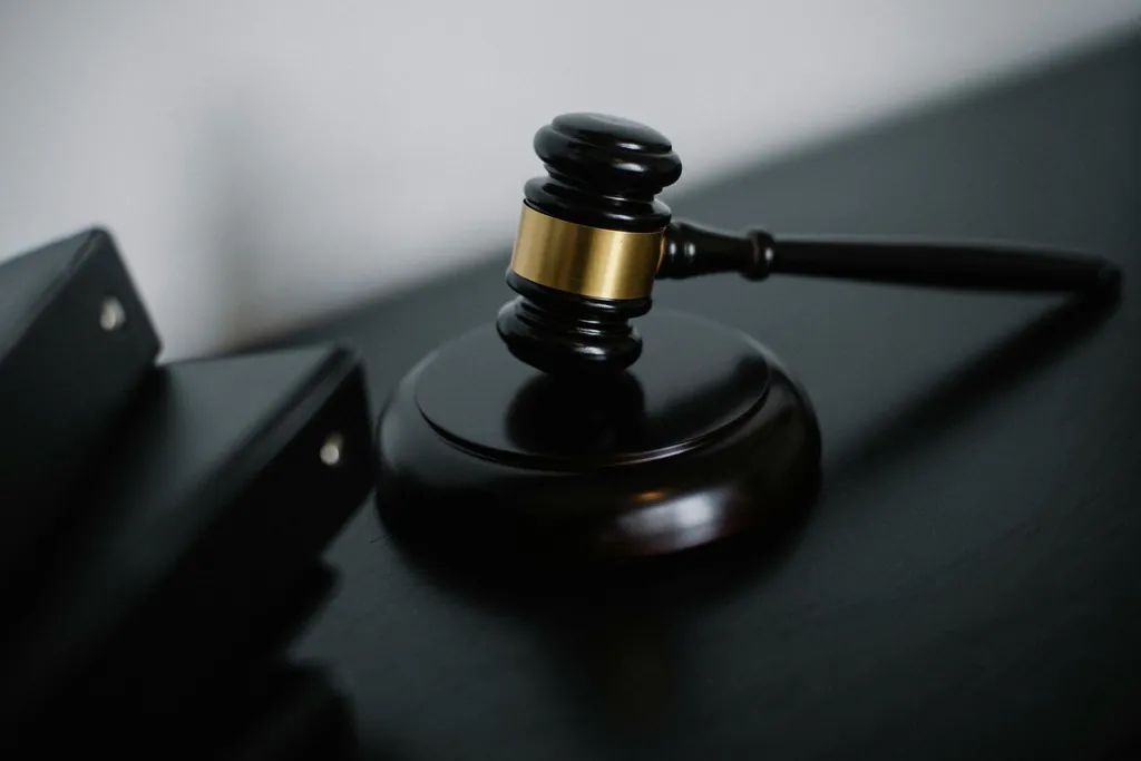 Judge's gavel on a black table in court
