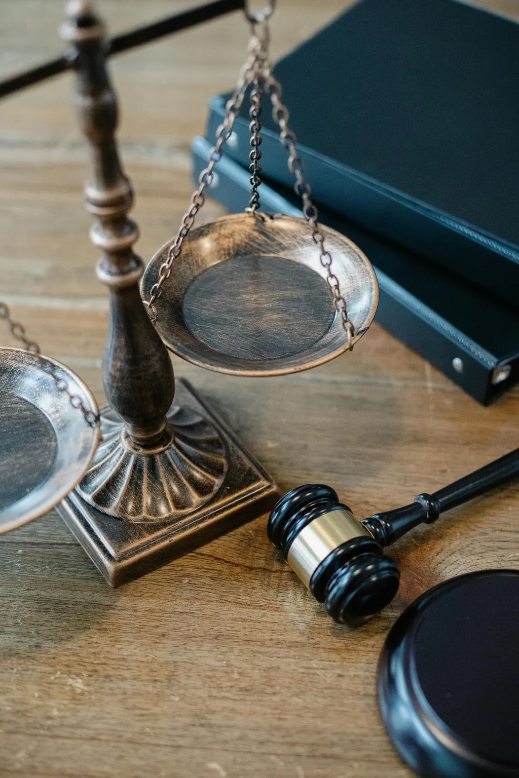 Scales of justice and a judge's gavel on a wooden table
