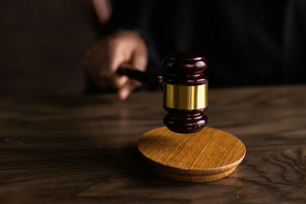 Judge holding a wooden gavel in an Illinois courtroom