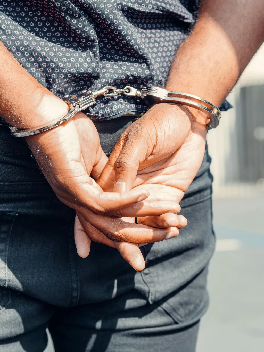 Close-up of handcuffed hands after a criminal arrest